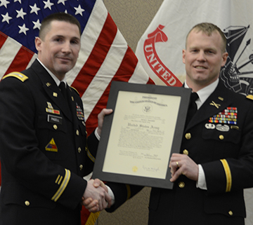 Major Sunsdahl receiving promotion plaque from LTC K. Dave Pindell.